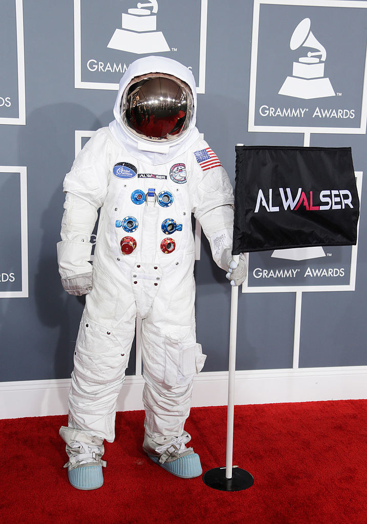 a full spacesuit with a helmet and a flag bearing his name