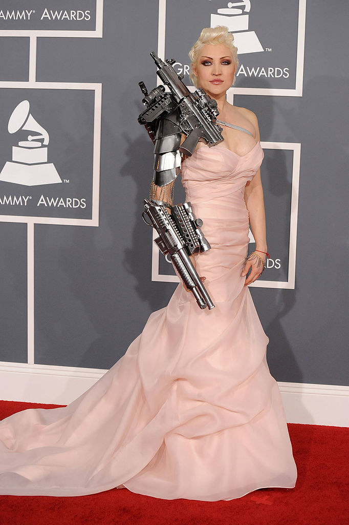 a ballgown and a mechanical weapon-looking arm sleeve