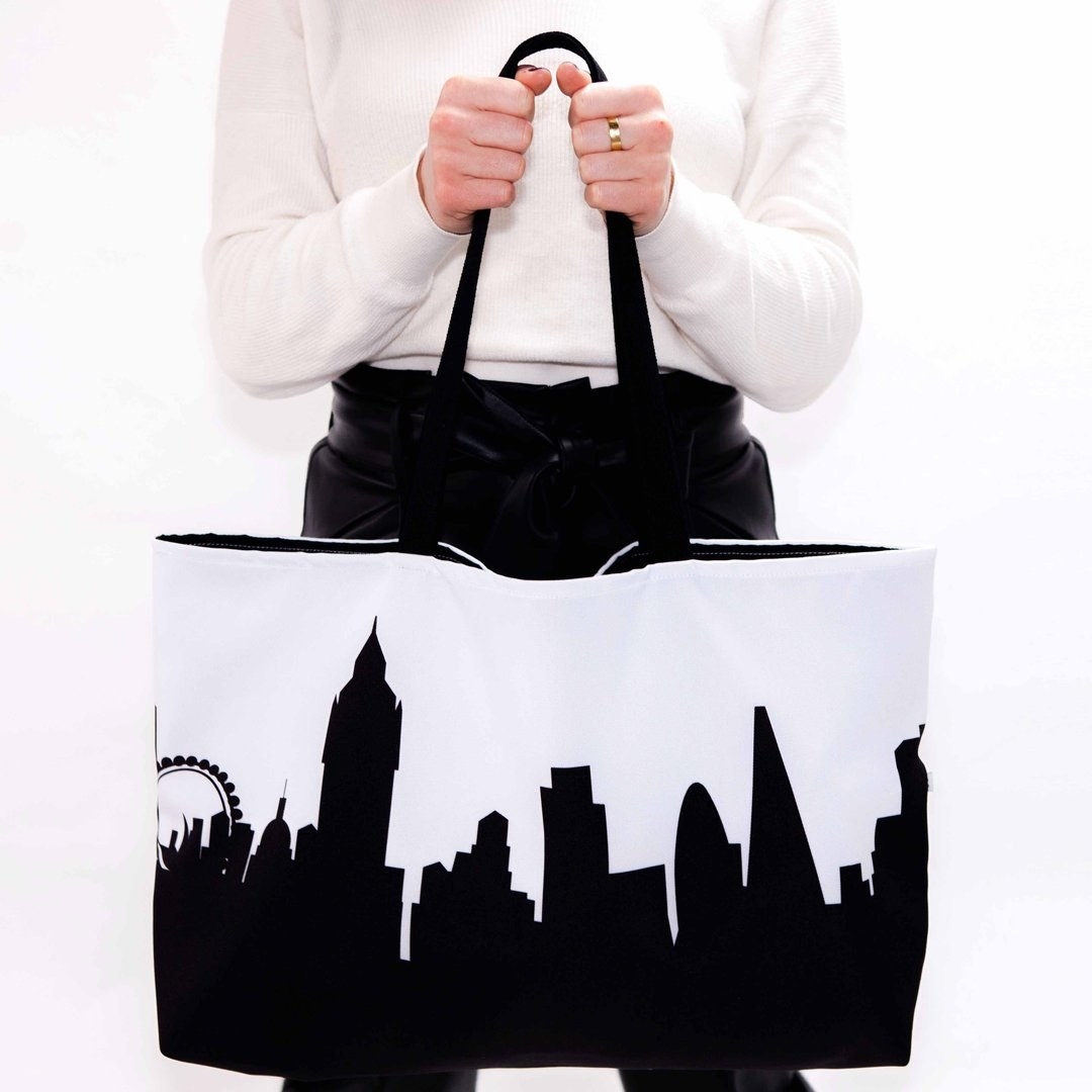 model holding london skyline tote bag