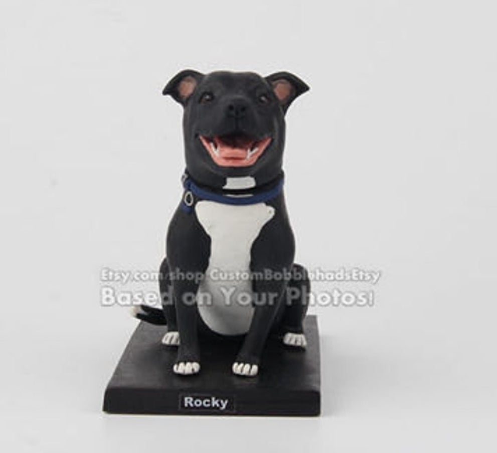 A bobblehead of a dog named Rocky