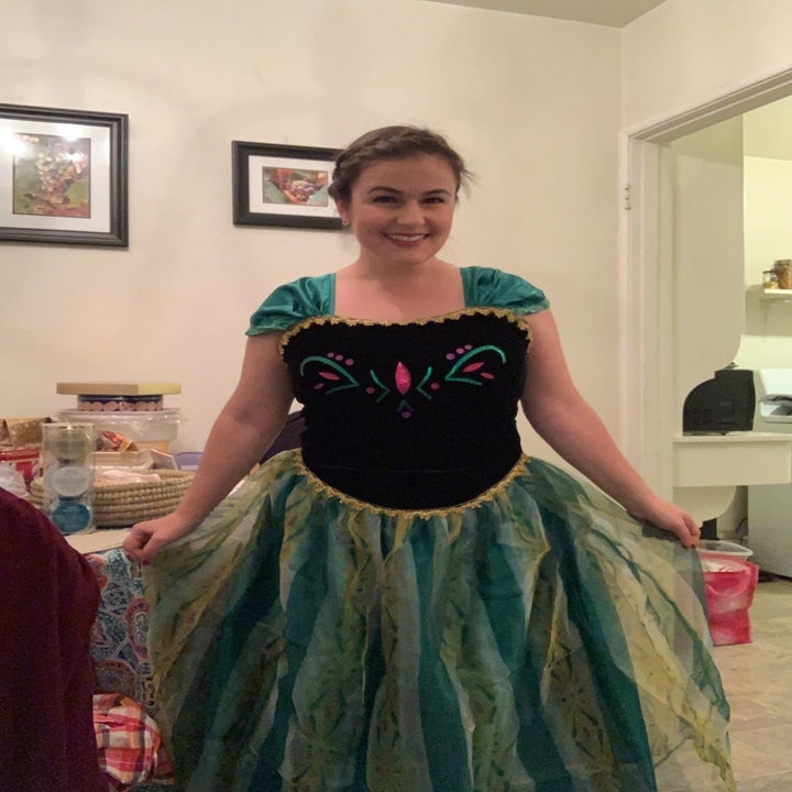 a reviewer wearing anna's coronation gown