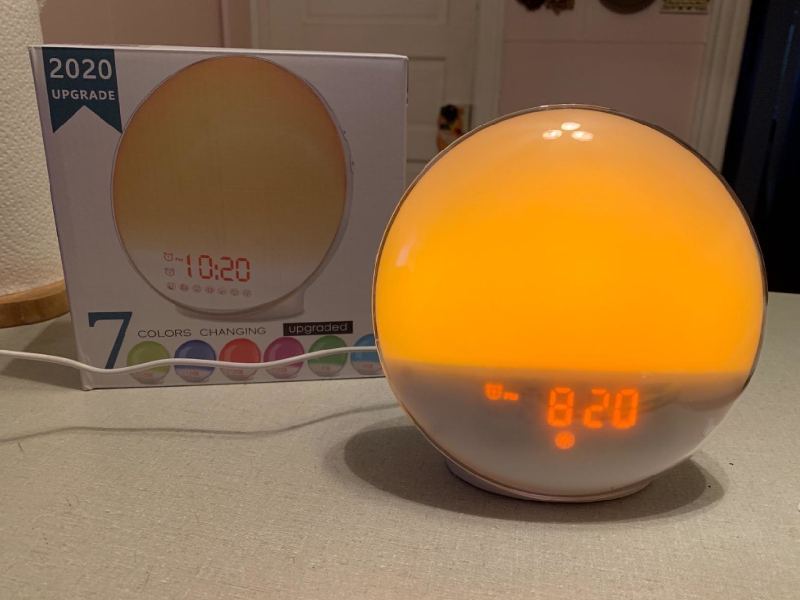 the alarm clock with the a soft yellow glow to simulate sunrise and sunset