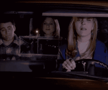 GIF of three people in a car looking ashamed after hitting something