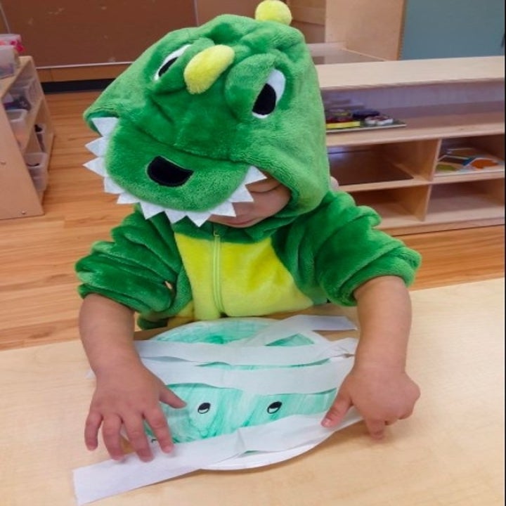 Reviewers child wearing dinosaur costume