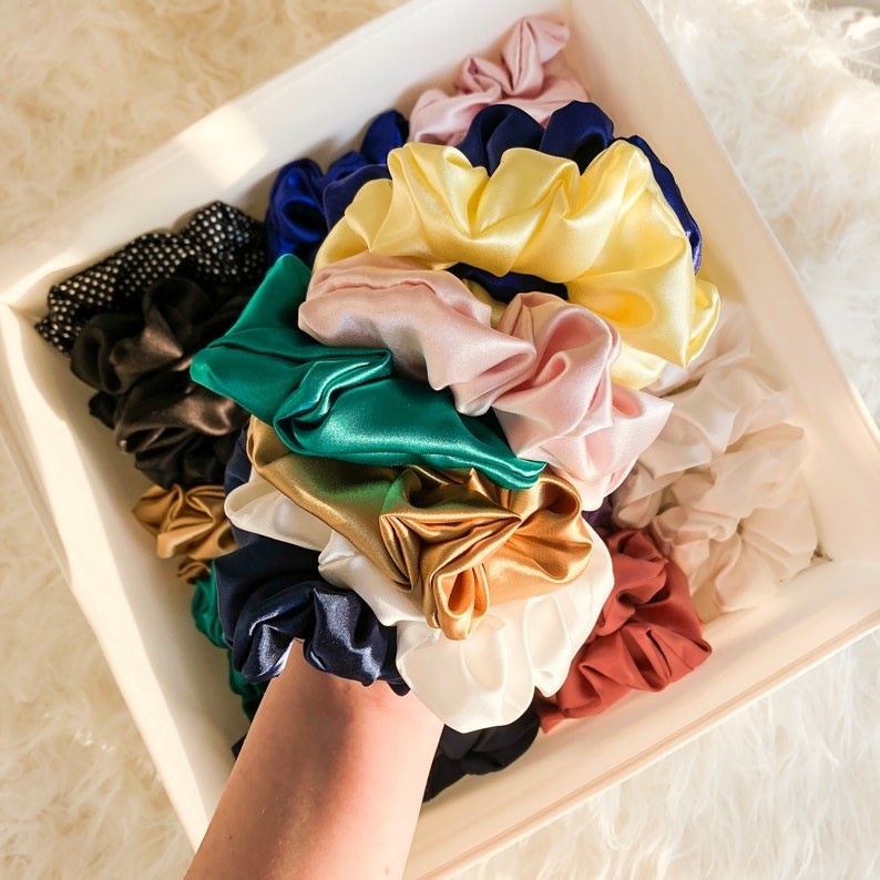 different colored silk scrunchies on wrist