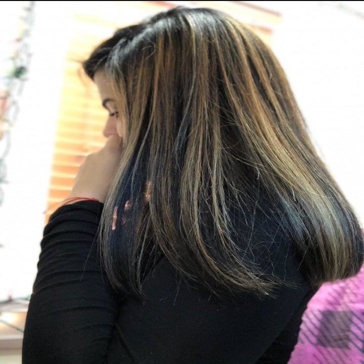 reviewer with longer colored hair looking silky