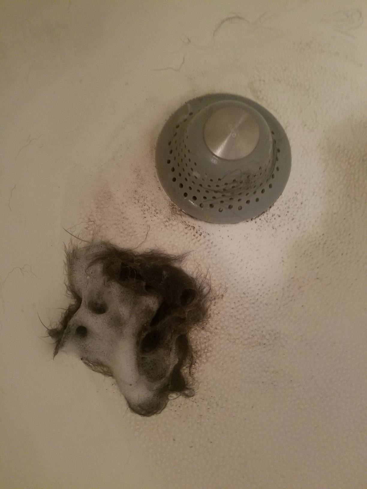 the drain protector in a reviewer&#x27;s drain with a clump of hair that it caught