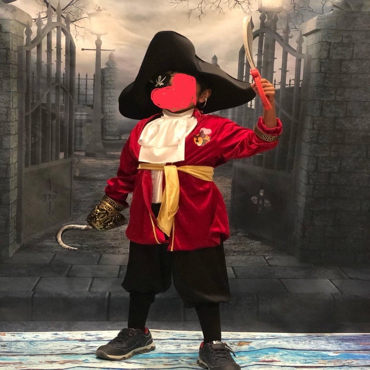 a reviewer's child wearing the red pirates coat with accessories