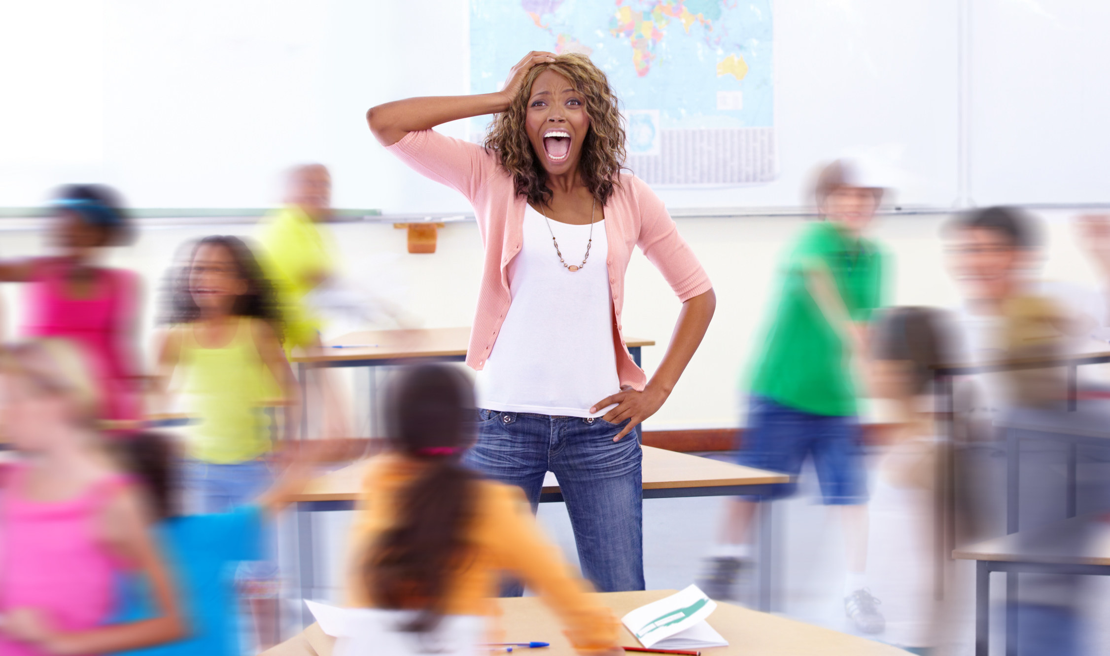 Distressed teacher screaming in the middle of her classroom