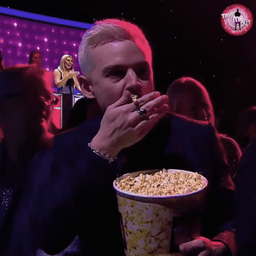 GIF man eating popcorn aggresively