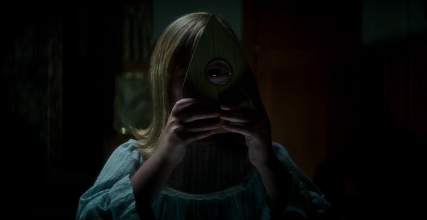 Doris looking through a planchette in &quot;Ouija: Origin of Evil.&quot;