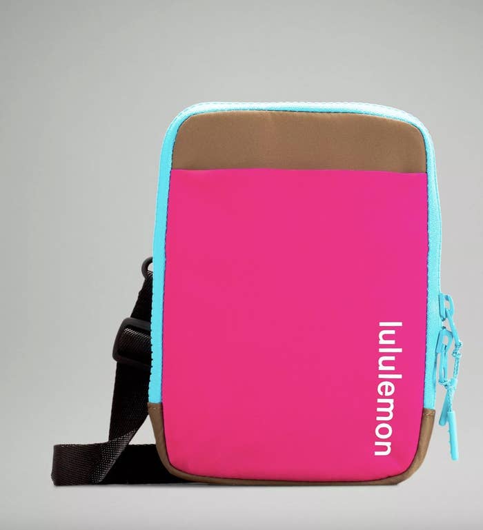 A pink, brown, blue, and black crossbody bag