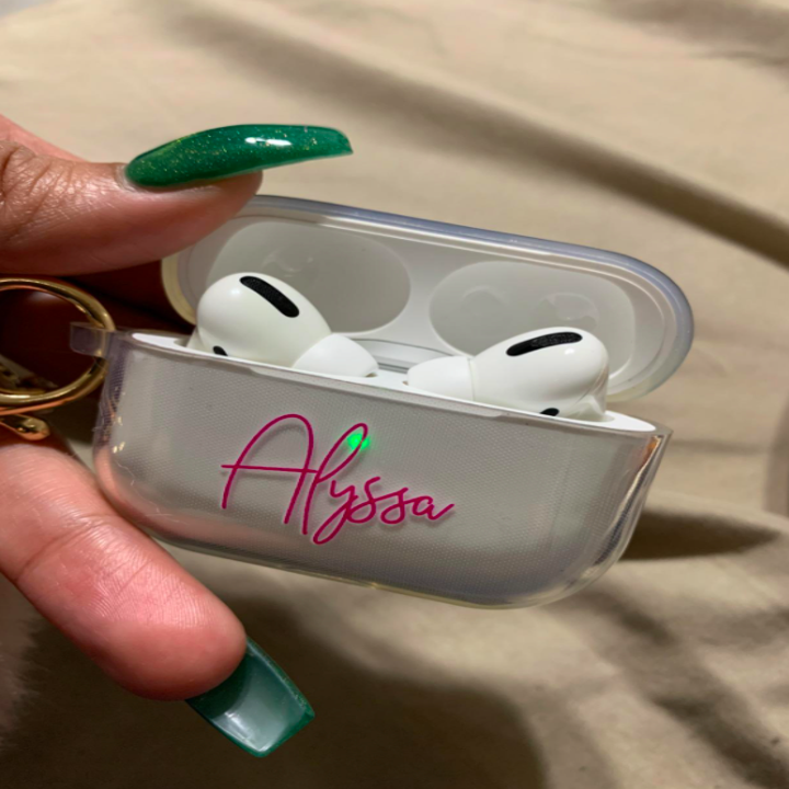 reviewer's hand holding the case that has the name "Alyssa" on it in pink cursive font