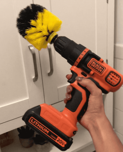 former buzzfeed editor holding a Black & Decker drill with the brush attached