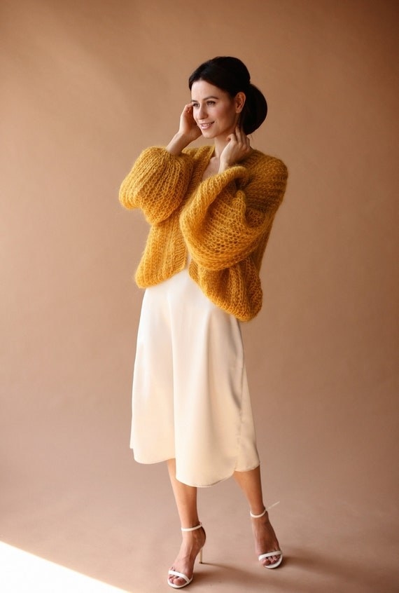 a model wearing the knit caridan in yellow
