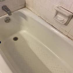 The same reviewer's photo of a clean white tub after using the drill brush