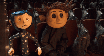 The character Coraline sits in a movie theater next to her friend and yells &quot;oh my god!&quot;
