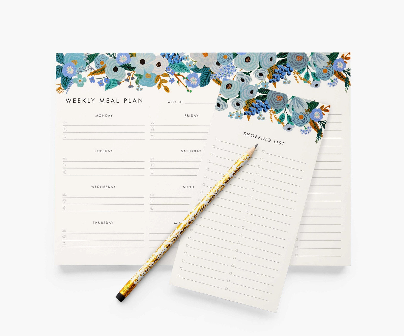 A cream rectangular pad with a blue floral design along the top and a section with each day of the week and lines to write, as well as a tearable numbered shopping list