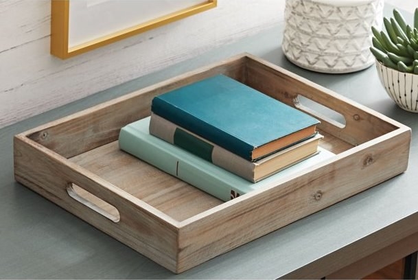 The tray with books in it.