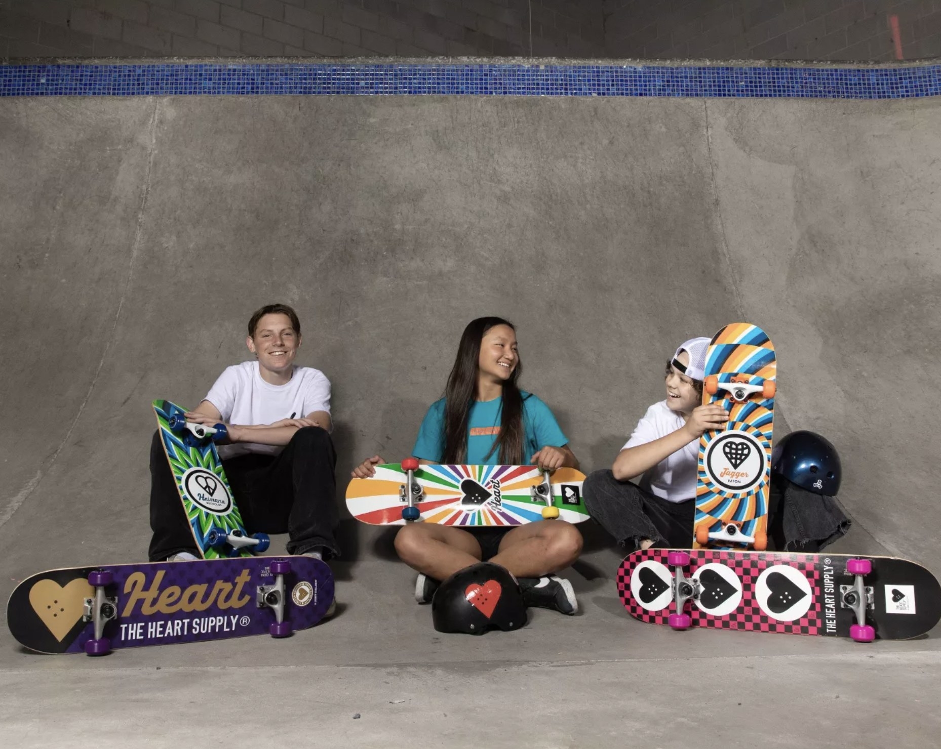 Three kids with their Heart Supply skateboards.