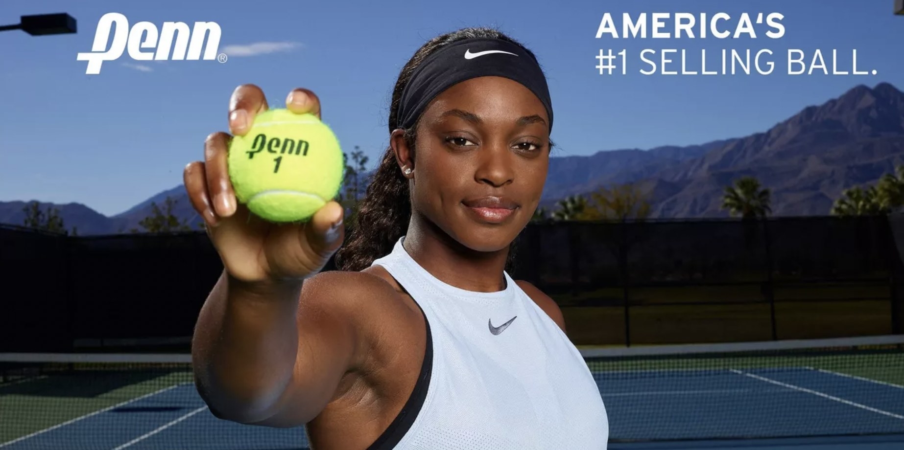 Woman holding Penn tennis ball