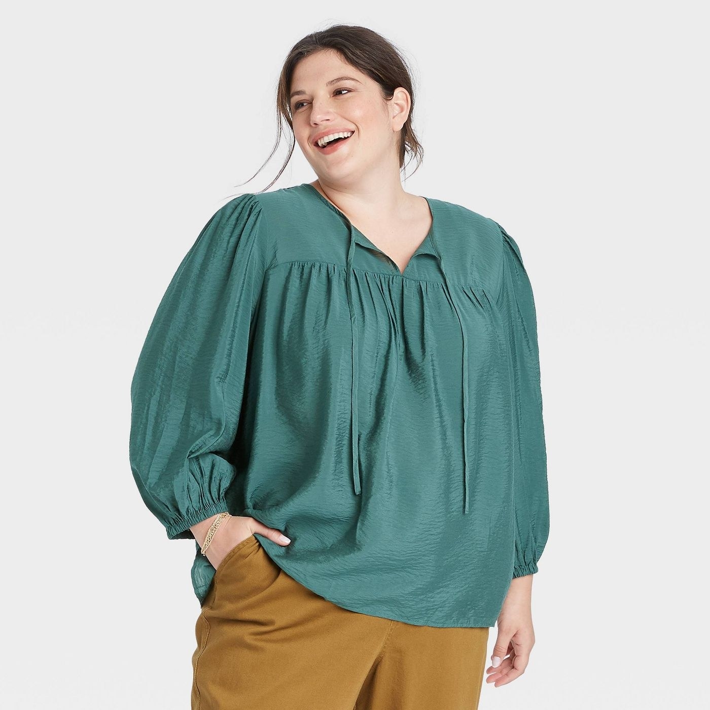 Model wearing the green balloon long-sleeve blouse