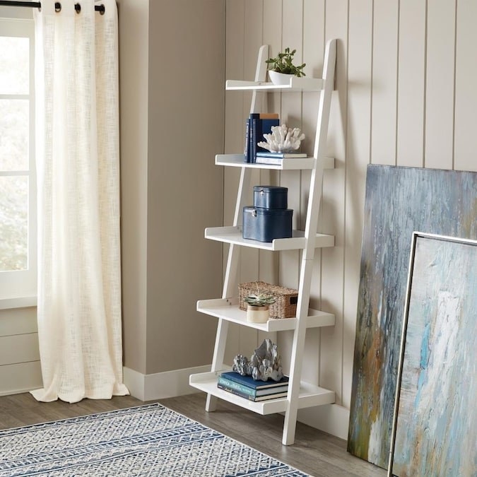 White ladder bookshelf filled with home decor