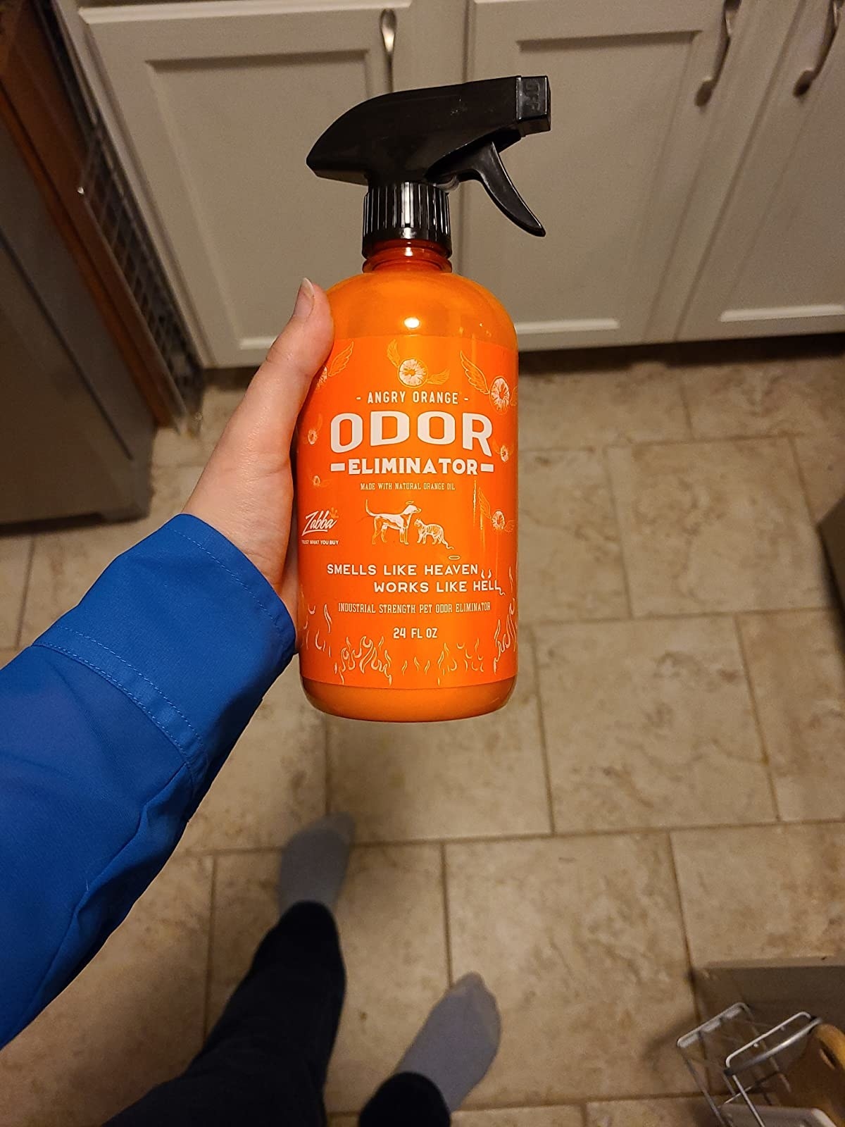image of reviewer holding the bottle of angry orange odor remover