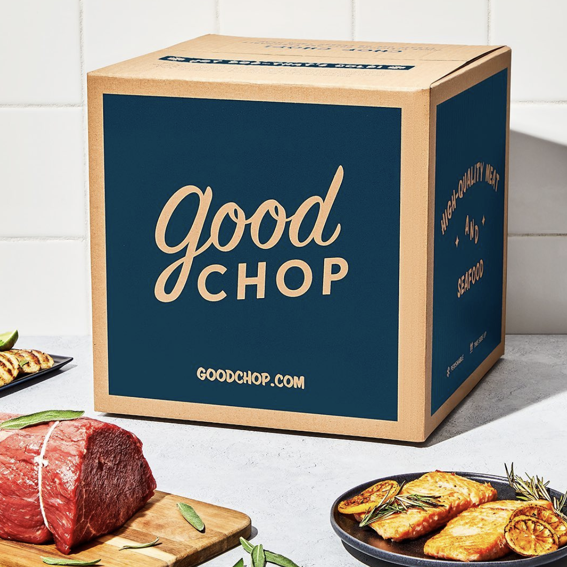 A Good Chop box with cuts of meat and fish next to it