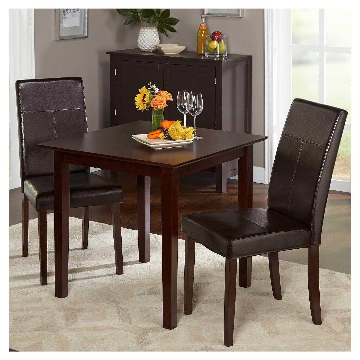 A dark brown table with chairs in home