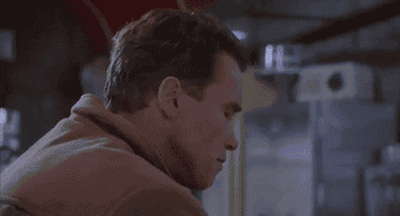 a gif of arnold schwarzenegger in jingle all the way doing an exaggerated double take