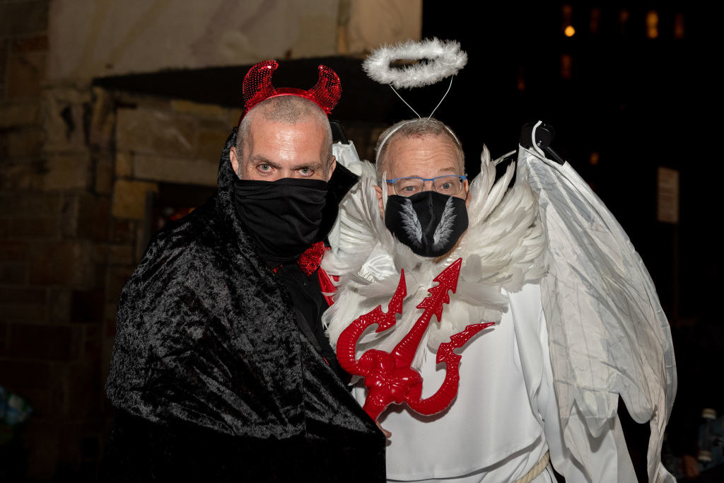 men dressed as a devil and angel