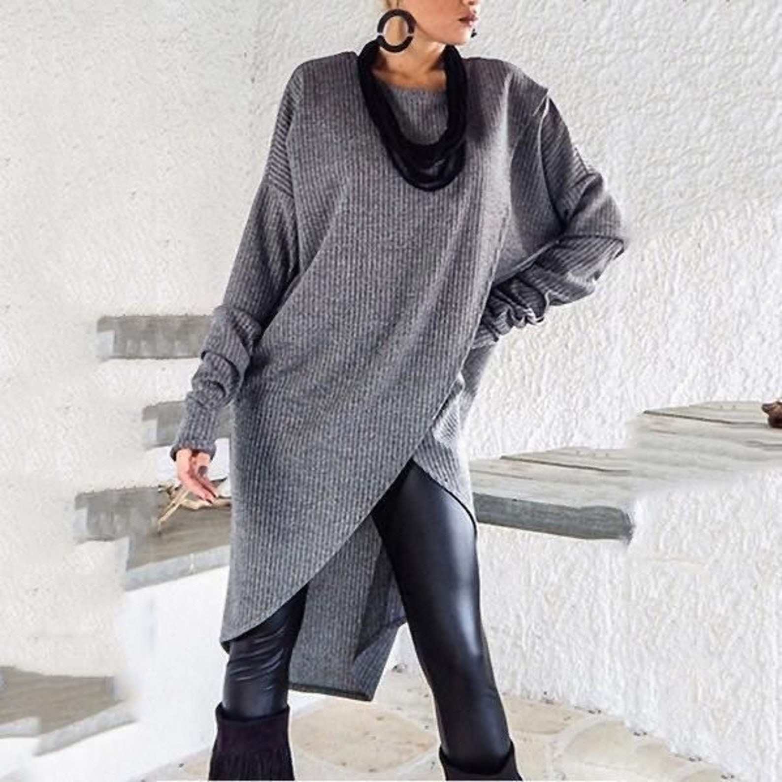 A model wearing the sweater dress in gray