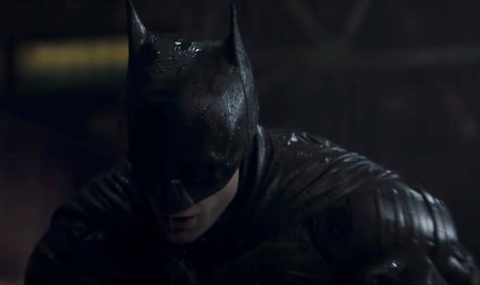A screenshot of Batman looking down in a dark space from the new film