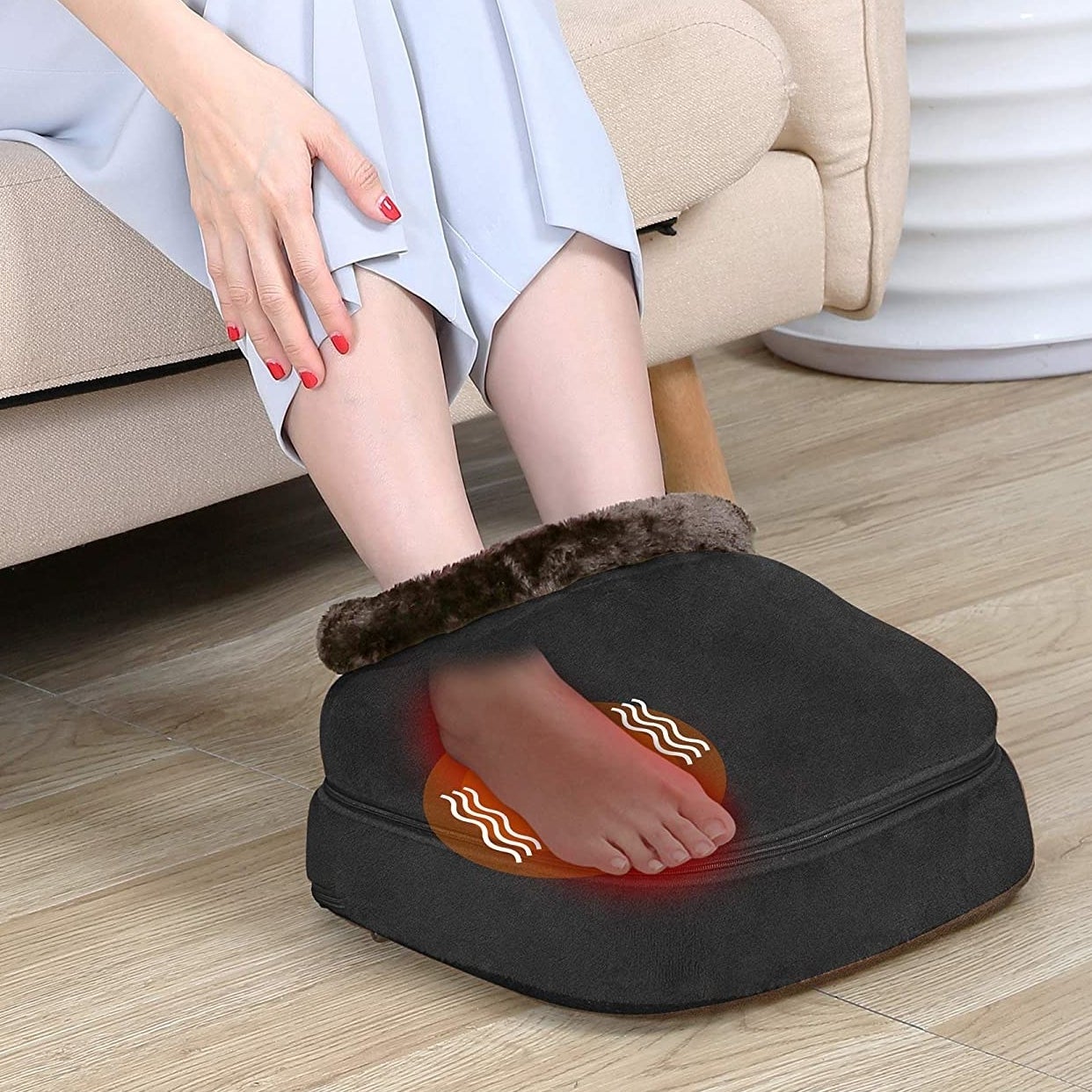 someone inserting their foot into the vibrating and heating foot massager