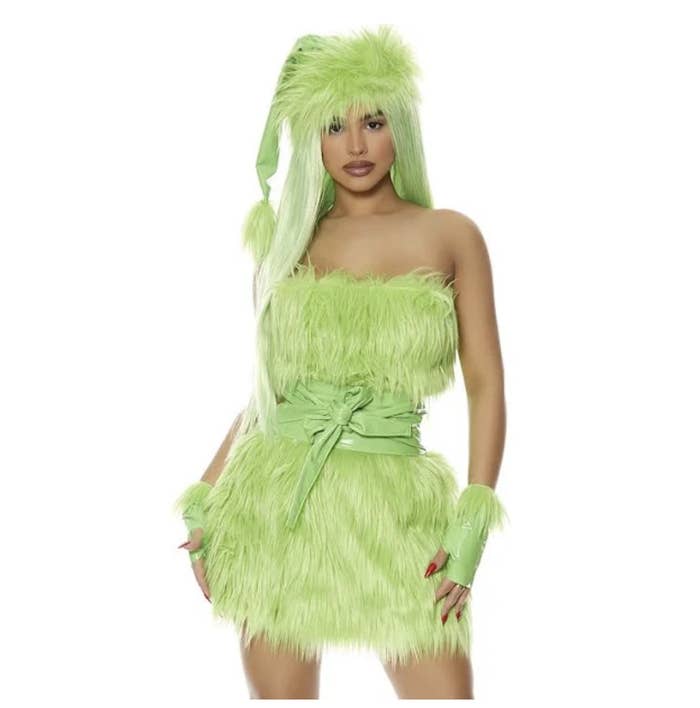 A woman wearing a furry green dress with a green wig and gloves