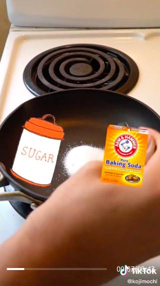 Someone adding sugar to a pan