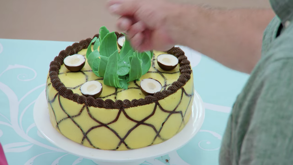 Crystelle&#x27;s pina colada cake, which is shaped like a pineapple