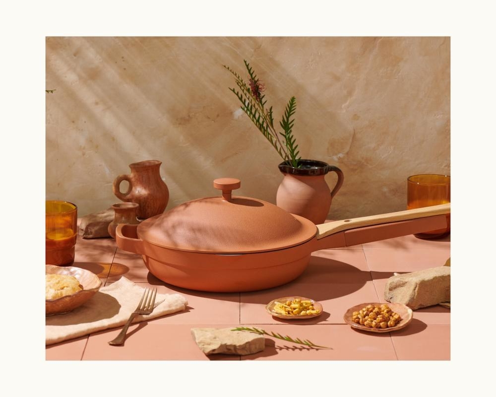 terra cotta Always Pan with attached wooden spoon on tiled table