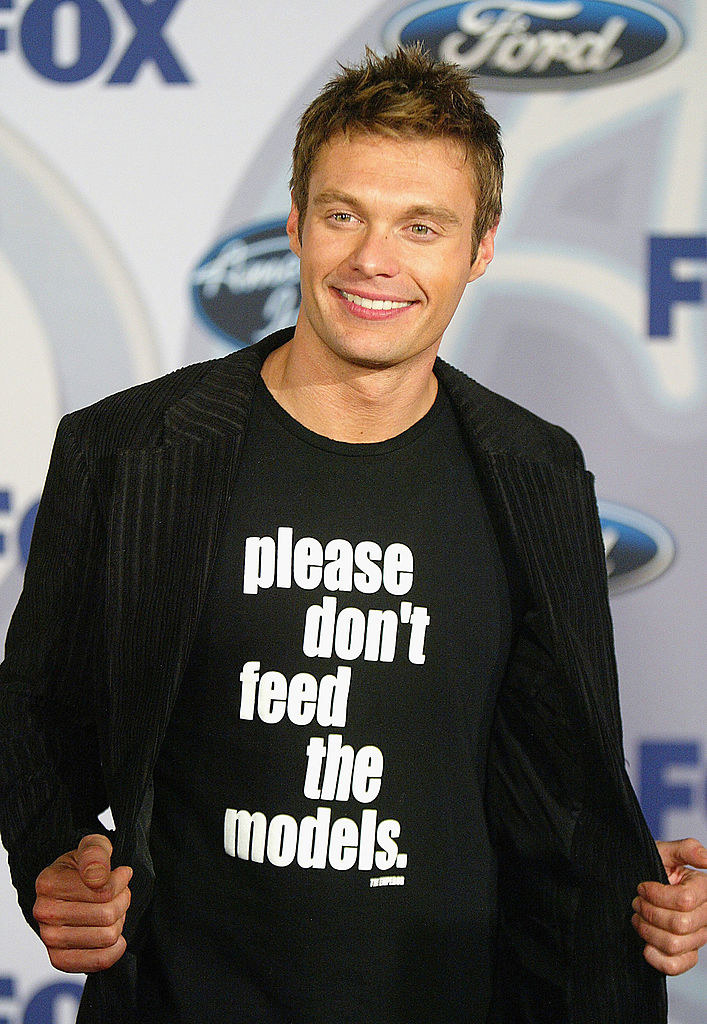 ryan seacrest wearing a please dont feed the models shirt