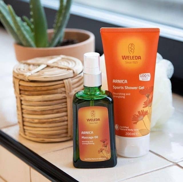 a bottle of massage oil on a tiled shelf
