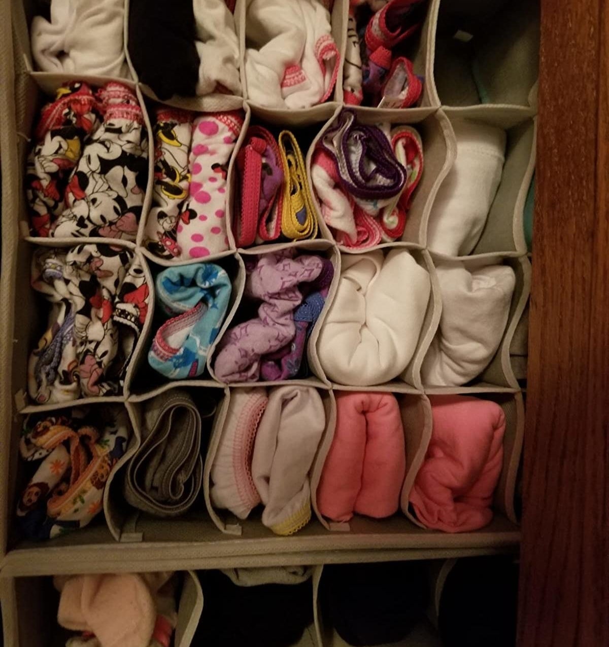 Reviewer&#x27;s photo showing their child&#x27;s underwear and pajamas neatly organized in the drawer