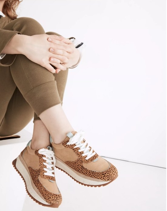 Model wearing brown cheetah print sneakers