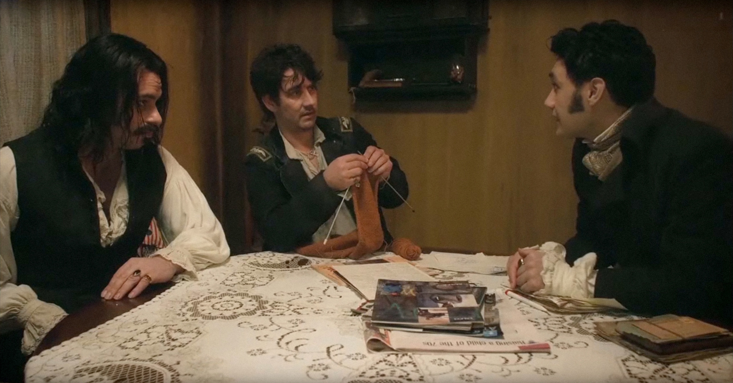 Jemaine Clement, Jonathan Brugh, and Taika Watiti talking at the table