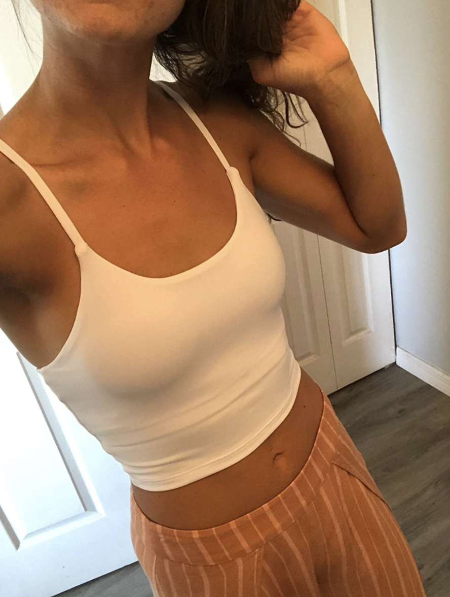 A reviewer wearing the top in white