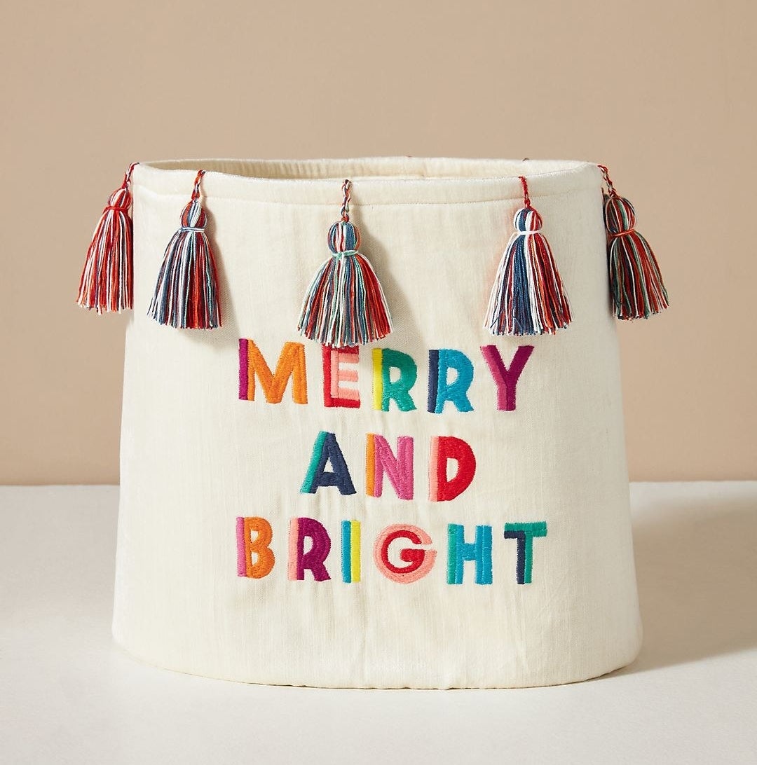 the cream bin with the words &quot;merry and bright&quot; in rainbow-colored text