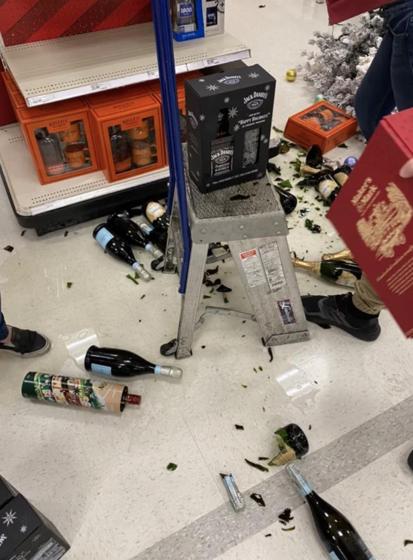 A bunch of broken champagne bottles near the Christmas/Halloween display
