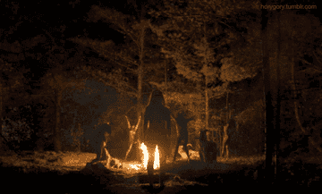GIF of witches floating up into the night sky around a fire
