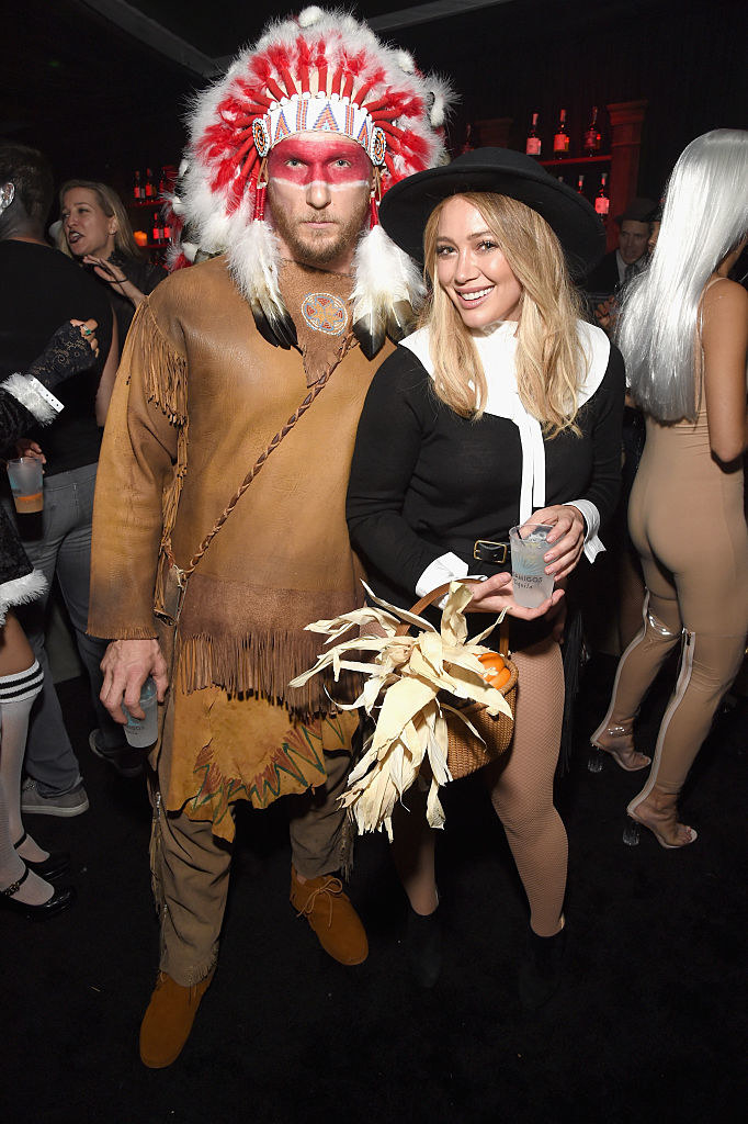 Jason Walsh dressed up as a Native American standing next to Hilary Duff, who is dressed up like a pilgrim
