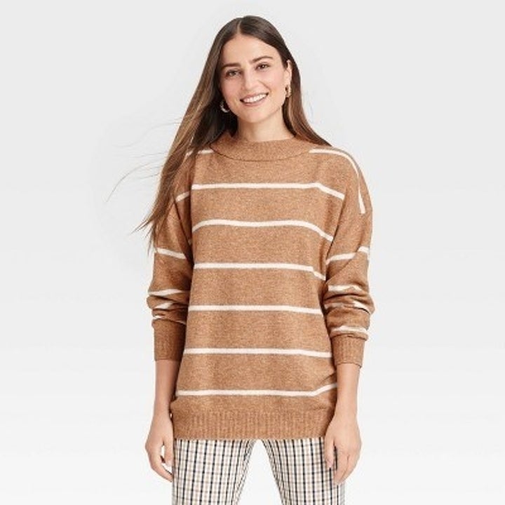 Model wearing the tan and white striped sweater
